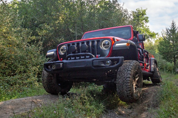 Jeep Gladiator review - red, tube doors, driving off-road showing suspension articulation