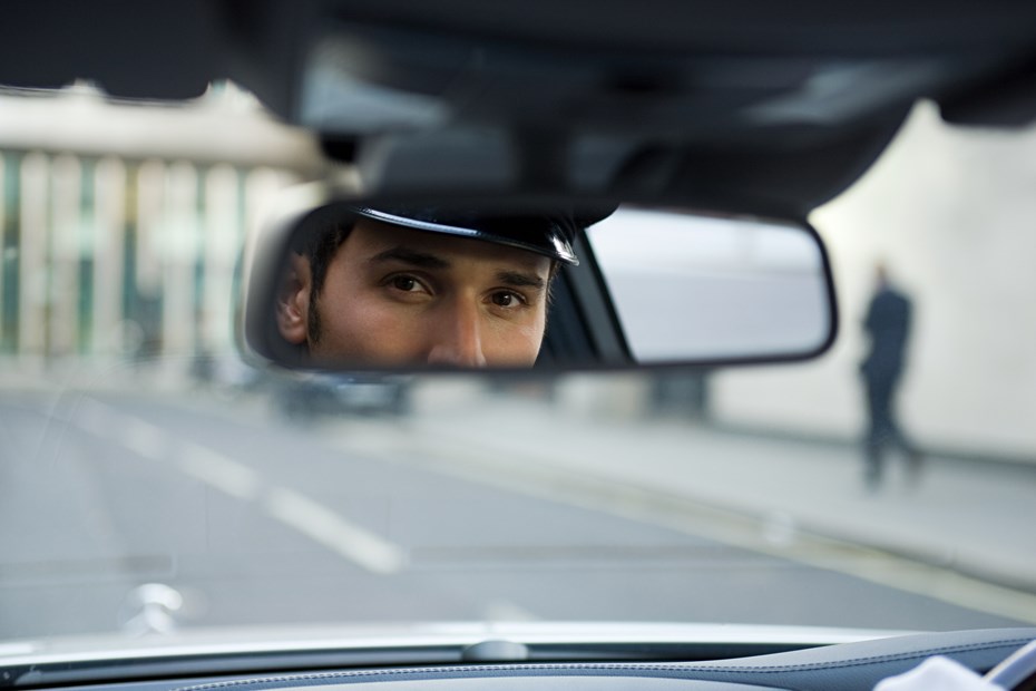 Man looking in a rearview mirror - Mirror dash cam