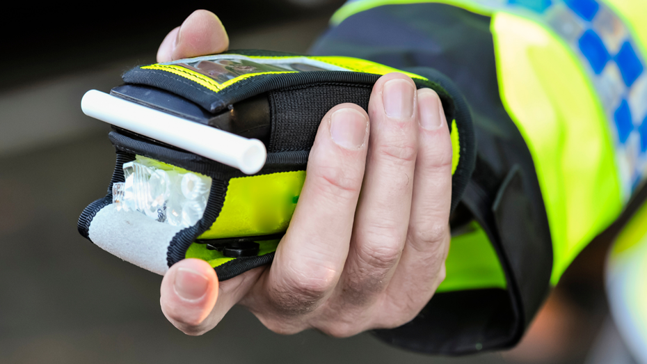 Breath test held by a police officer