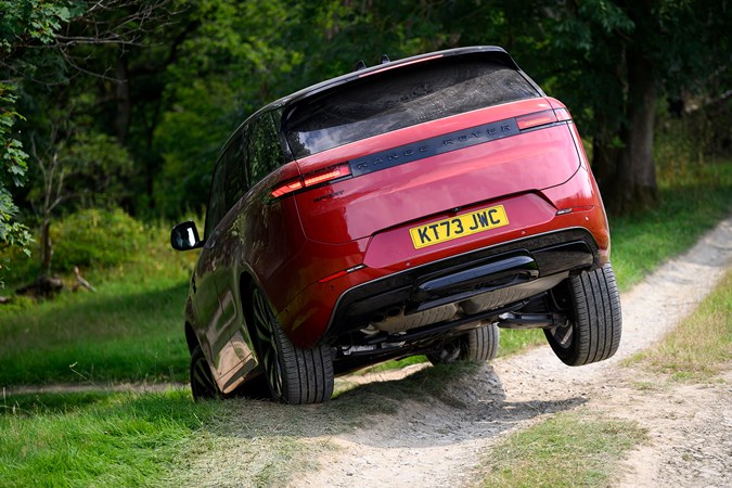 How to drive off-road: Range Rover Sport, driving on a gravel road, low angle, lifting a rear wheel, red paint