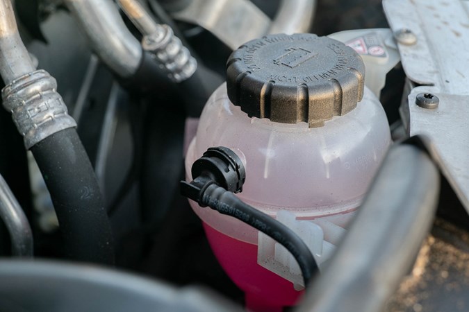 Clean coolant isn't a cause for concern. If it's murky pink/red, black, or dark green/blue, it should be changed. Green/blue coolant is harmful to wildlife if it leaks