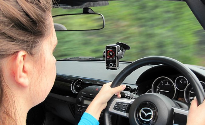 It's fine to have your phone in a holder while driving, but it's better to have it out of sight.