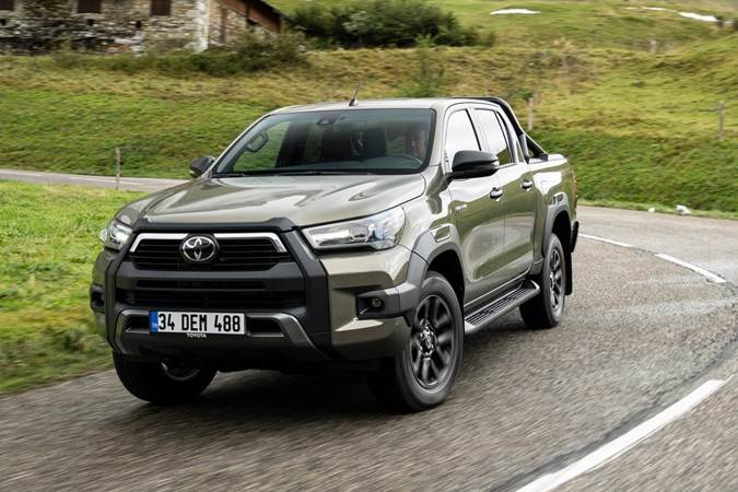 2020 Toyota Hilux facelift - front view, driving round corner, Titan Bronze