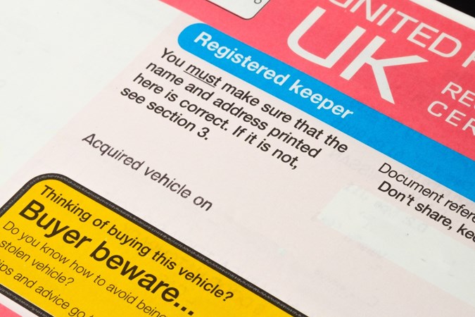 Close up of UK car registration showing 'registered keeper' text