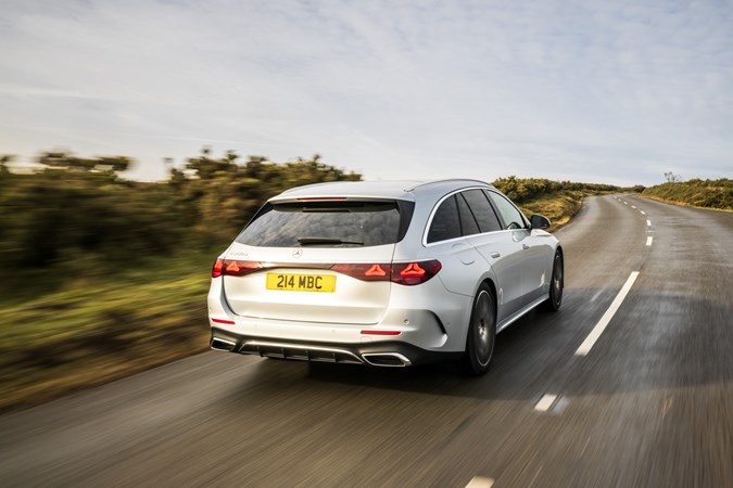 Image of a silver Mercedes E-Class estate, driving, from the rear right corner