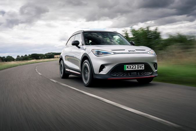 A silver Smart #1 Brabus driving on a cloudy day