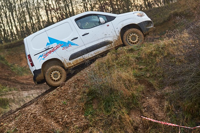Vauxhall Combo Cargo 4x4 review - white, side view, climbing muddy slope