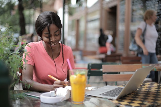 Woman at a cafe table with a laptop