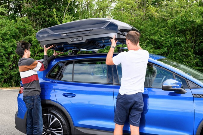Oli Reed and Aaron Hussain mounting a roof box to Skoda Elroq