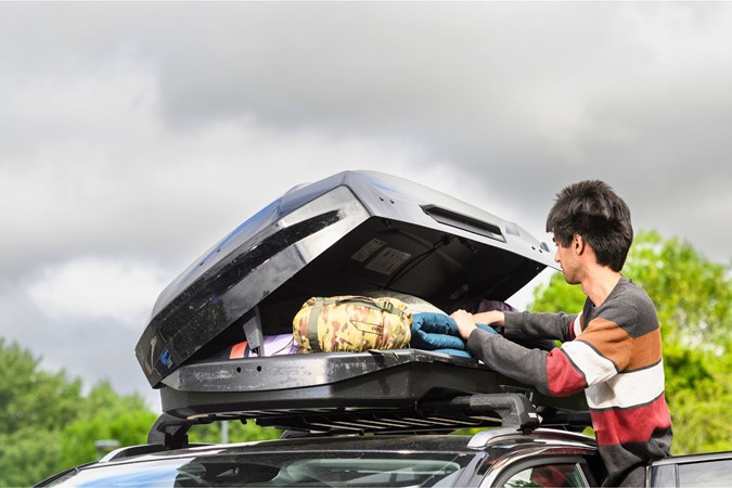 Aaron Hussain loading up a Thule Motion 3L roof box