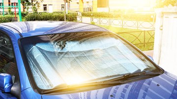 Windscreen cover on blue car