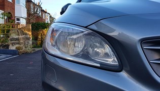 A close up shot of a Volvo's headlight bulb, including the H7 bulb