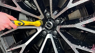 Sonic Scrubber Pro Detailer being used on a wheel