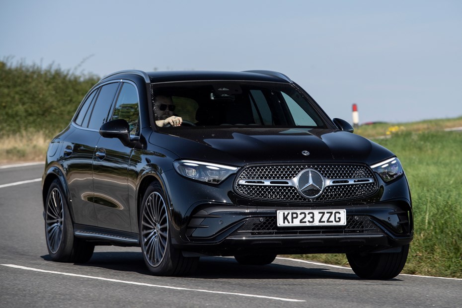 Mercedes GLC (2023) review: front three quarter driving, black car, rural B-road