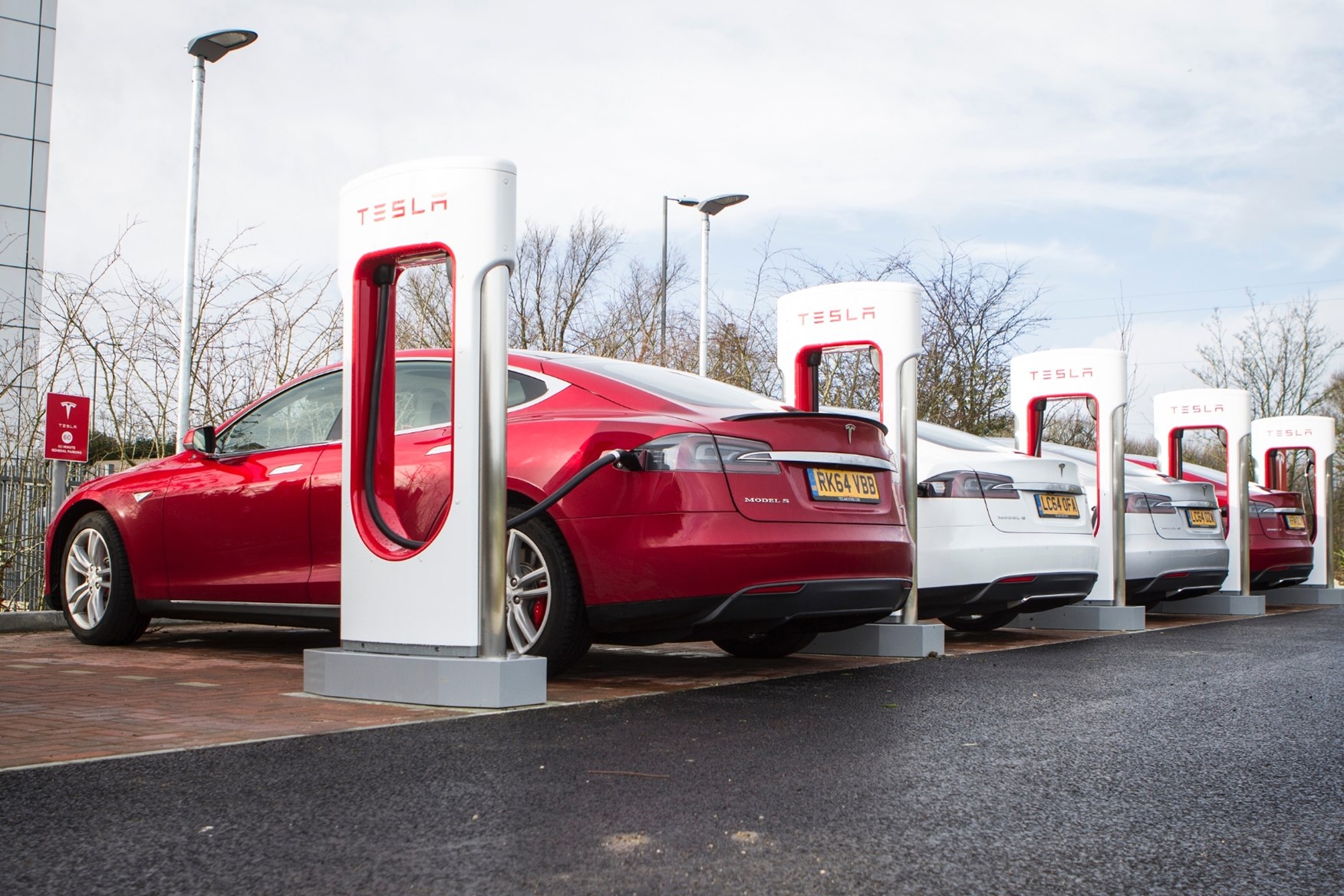  A red Tesla Model S is on fire at a Tesla Supercharger station in Pennsylvania.