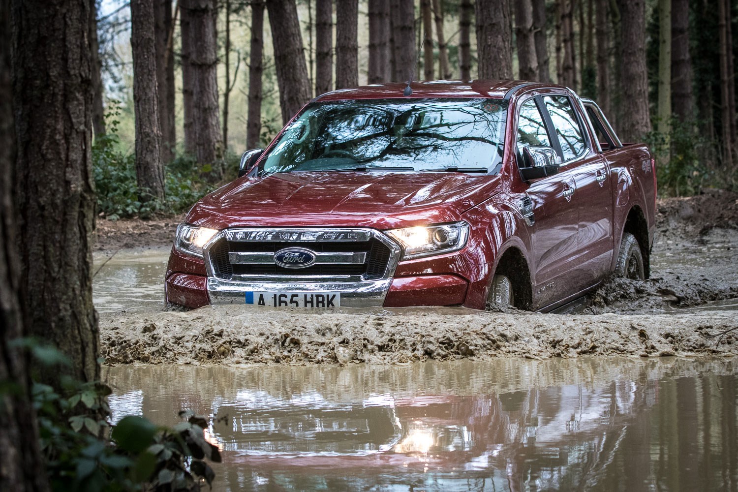 Ford Ranger review - 2016 facelift, wading through mud, dark red metallic, Limited
