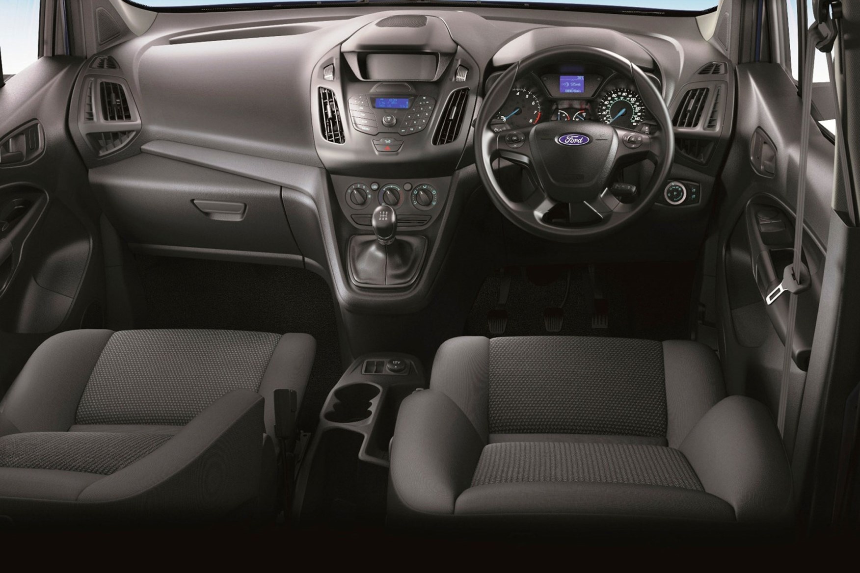 Ford Transit Connect review - 2013 cab interior showing steering wheel and dashboard, basic radio, lots of buttons