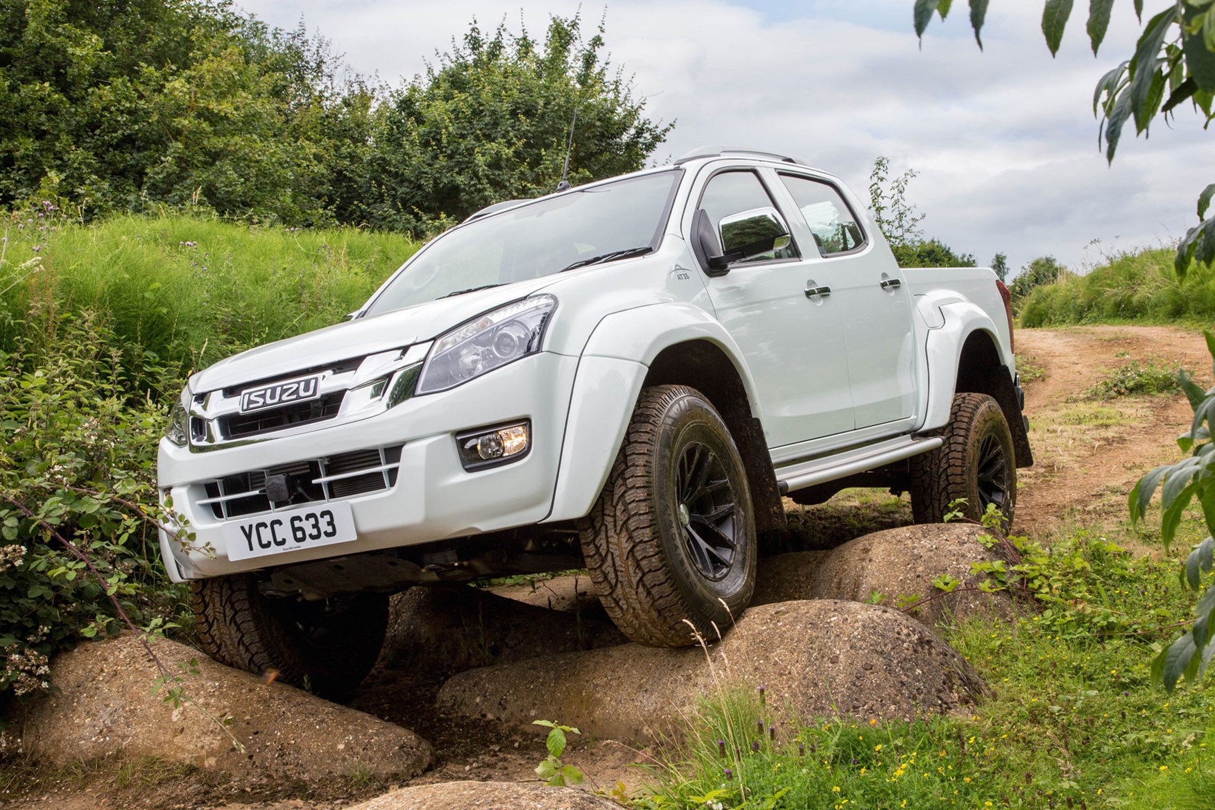 Isuzu D-Max AT35 2.5 review -  front view, climbing over large rocks, white