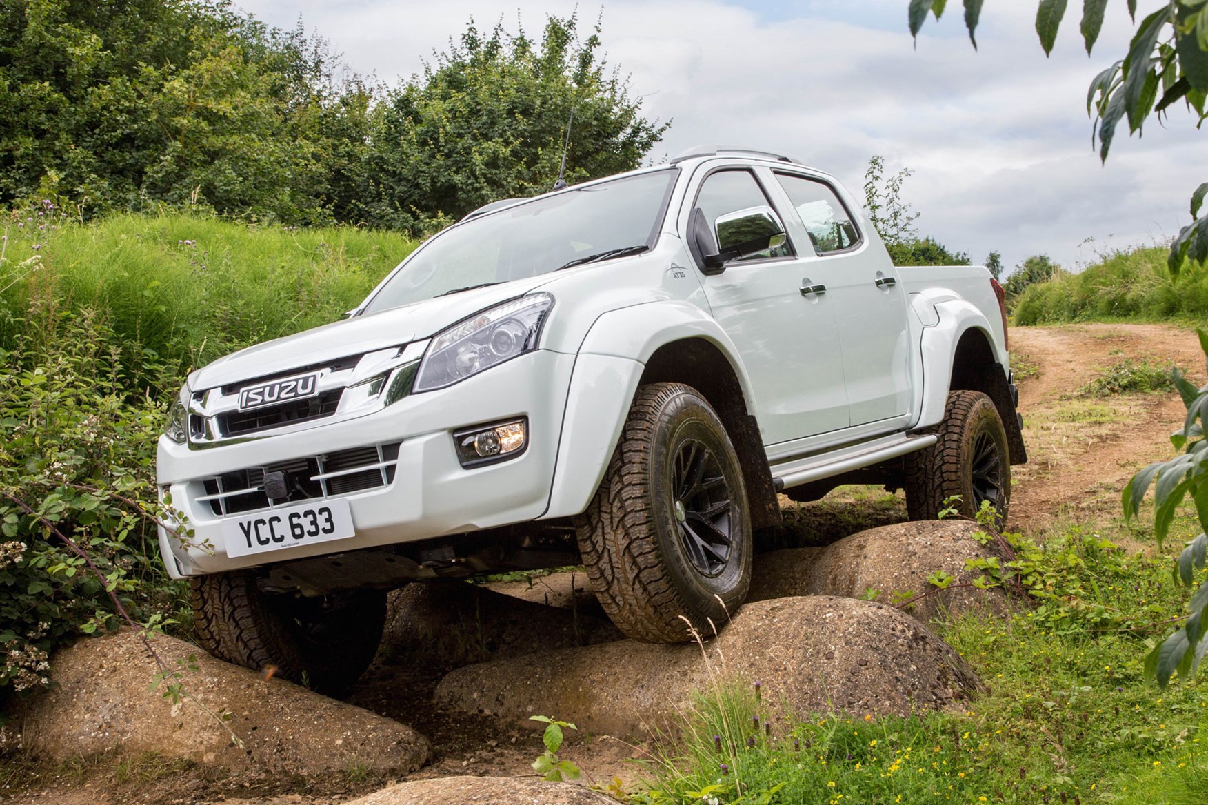 Isuzu D-Max AT35 2.5 review - front view, climbing over large rocks, white