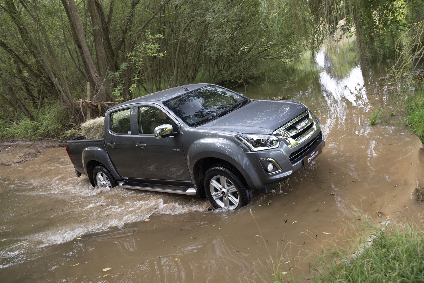 Isuzu D-Max Yukon review - wading through muddy water, grey