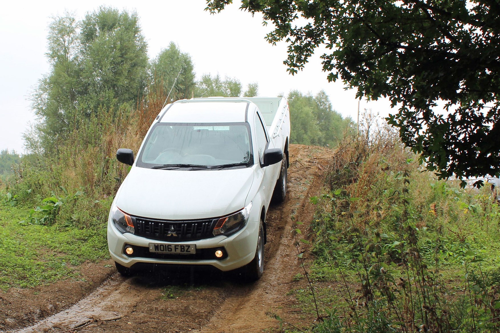 Mitsubishi L200 4Life Single Cab review - front view, driving down slope off-road, white