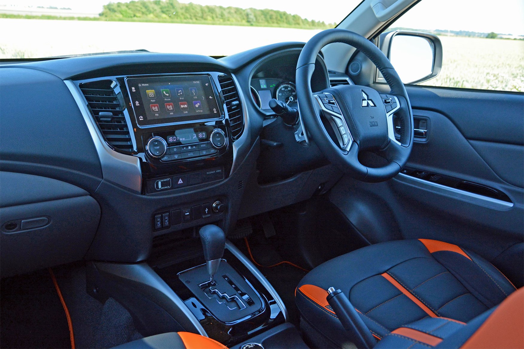 Mitsubishi L200 Barbarian SVP II review - cab interior, steering wheel, dash board, black and orange