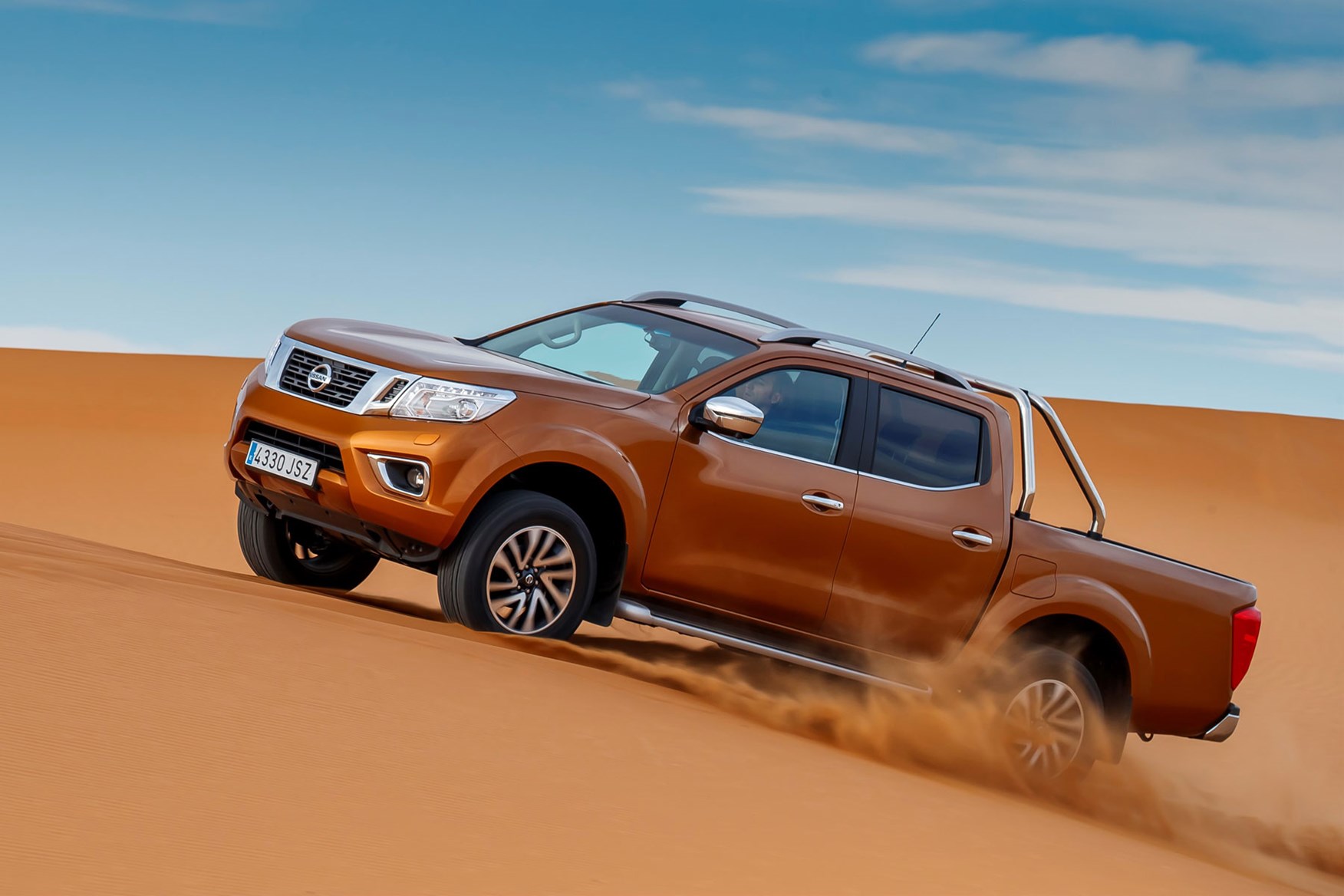 Nissan Navara Tekna review - driving in the Sahara Desert, side view, orange, climbing dune