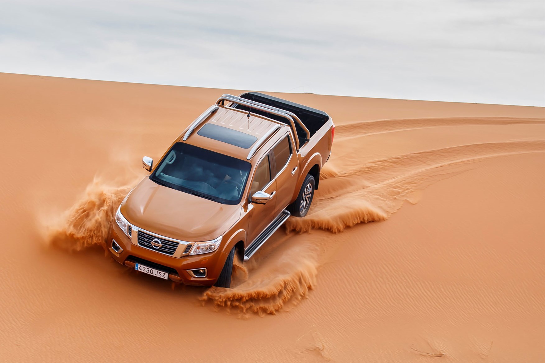 Nissan Navara Tekna review - driving in the Sahara Desert, top view, orange, driving down sand dune