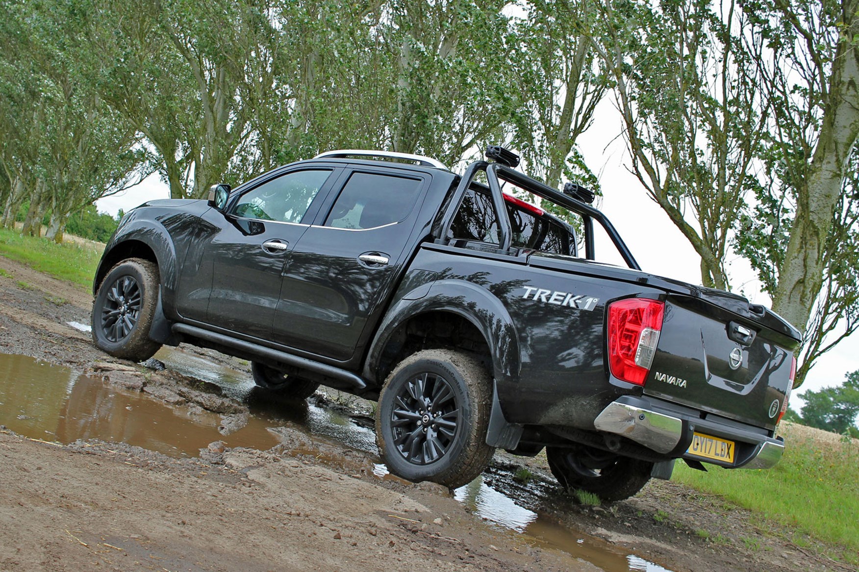 Nissan Navara Trek-1 review - rear view, black, parked in muddy puddle