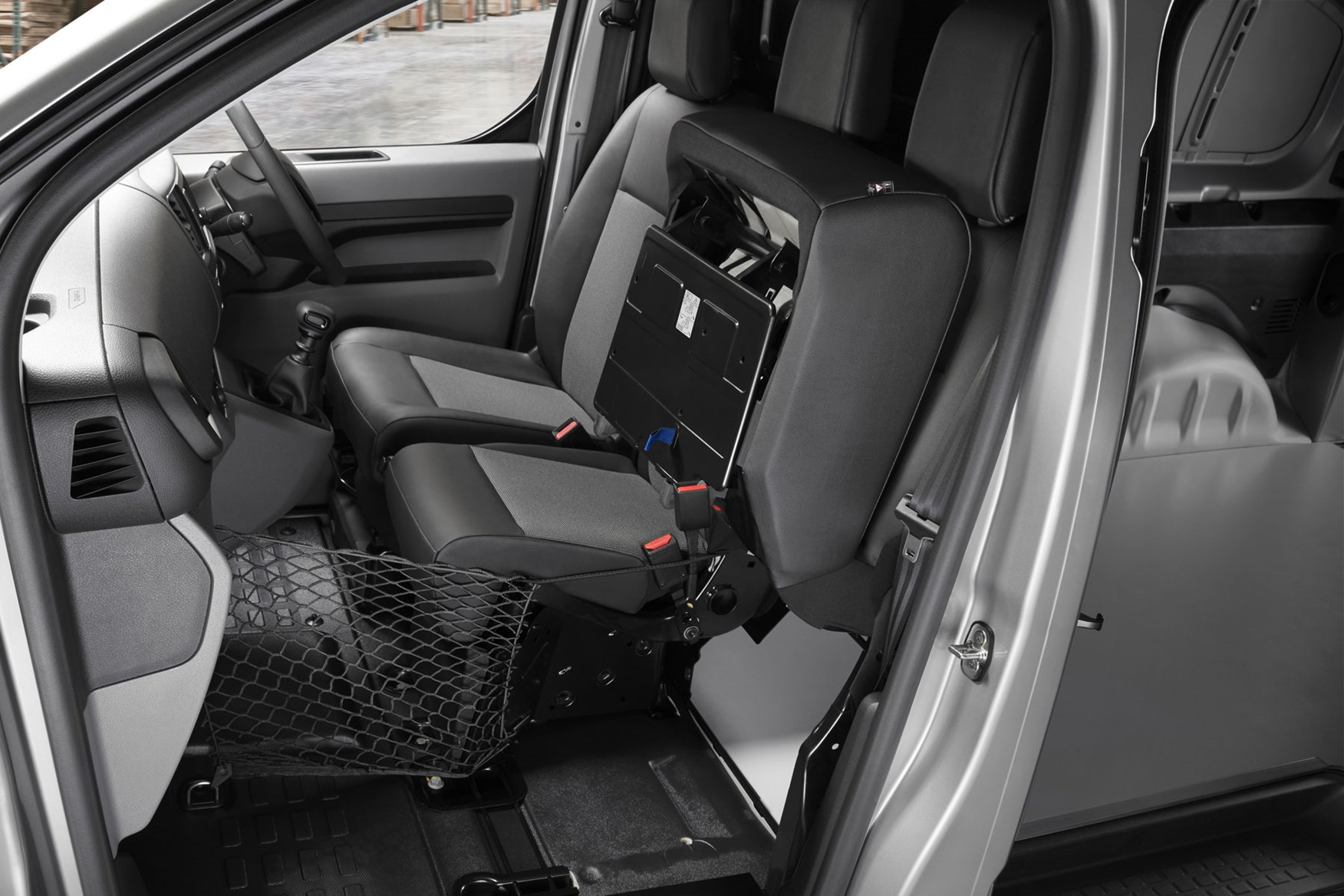 Peugeot Expert - 2016 model, cab interior viewed from passenger side, Moduwork bulkhead with passenger seat folded up and net fitted