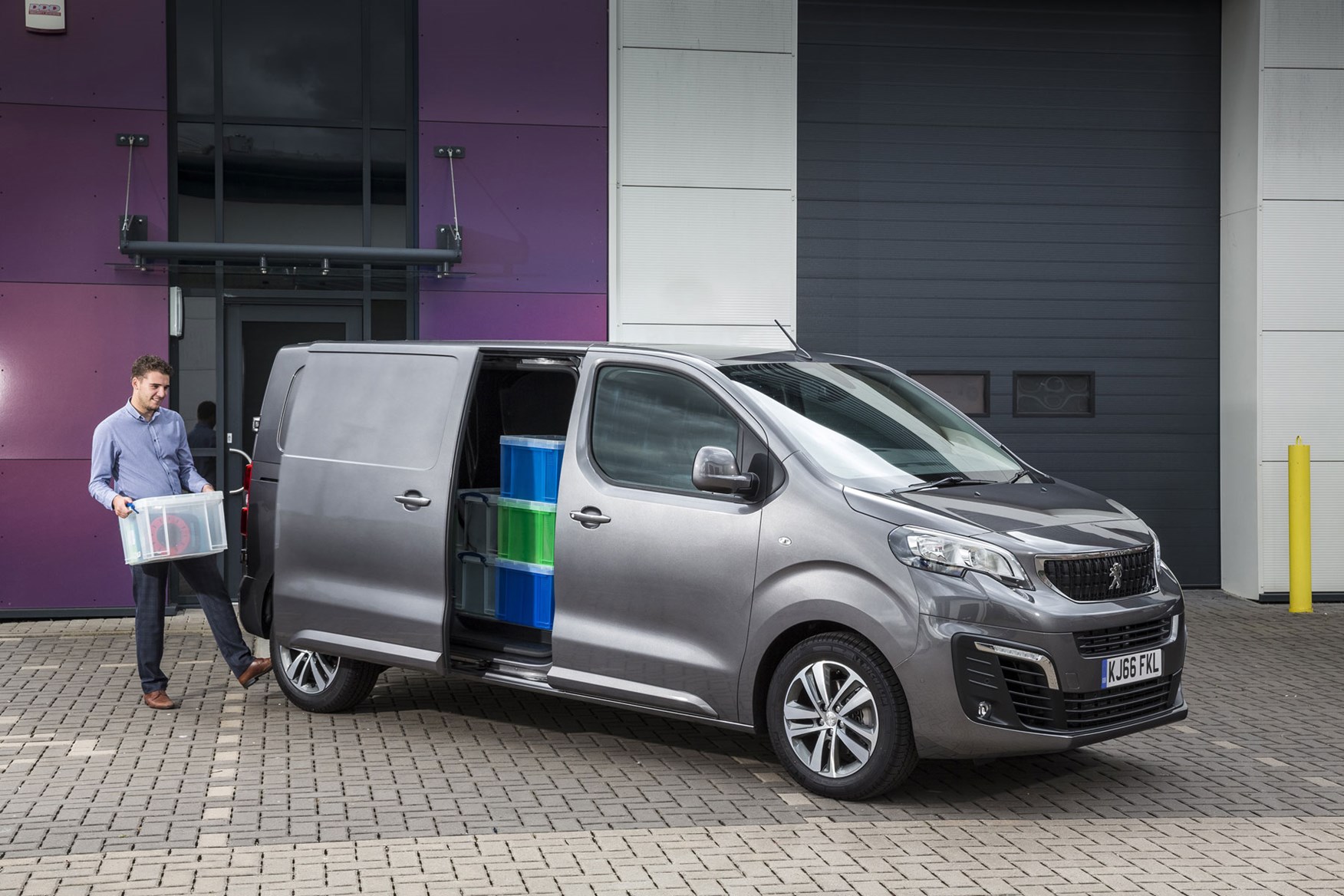 Peugeot Expert - 2016 model, front view, loaded van with man activating electric side doors with foot