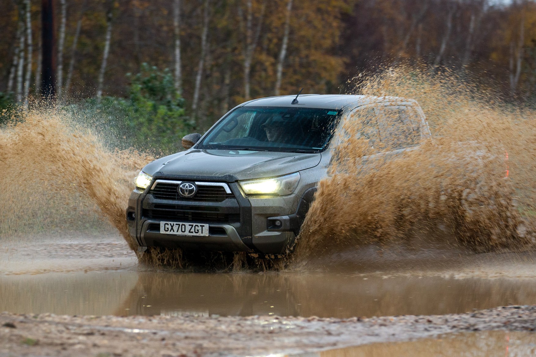 Toyota Hilux review, 2020 facelift, front view, big splash through muddy water, bronze