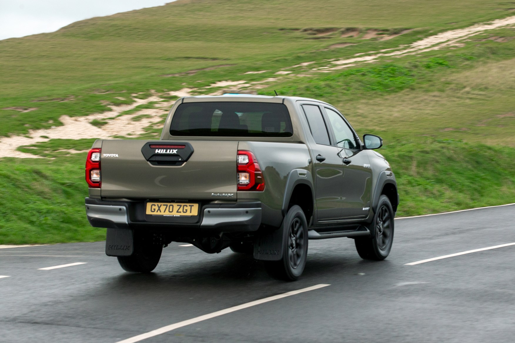 Toyota Hilux review, 2020 facelift, Invincible X, driving, rear view, bronze