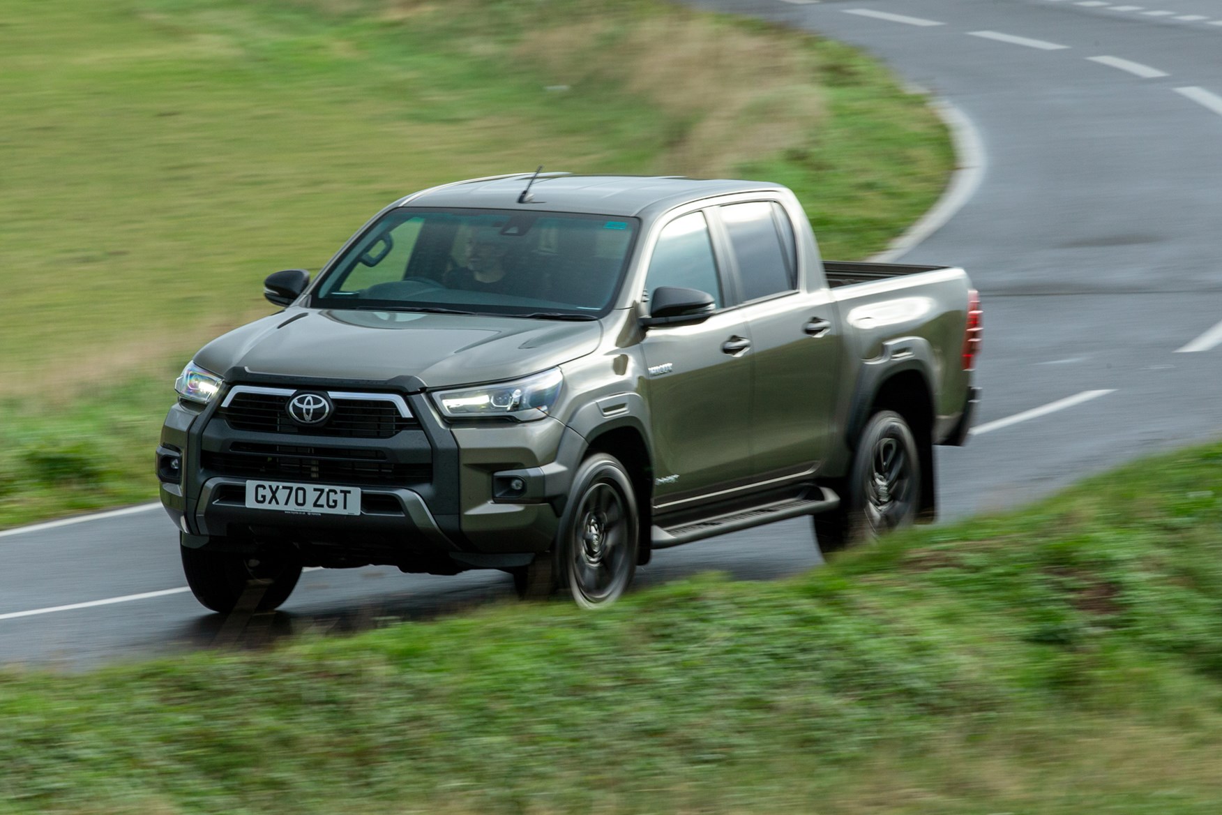 Toyota Hilux review, 2020 facelift, Invincible X, driving round corner, front view, bronze