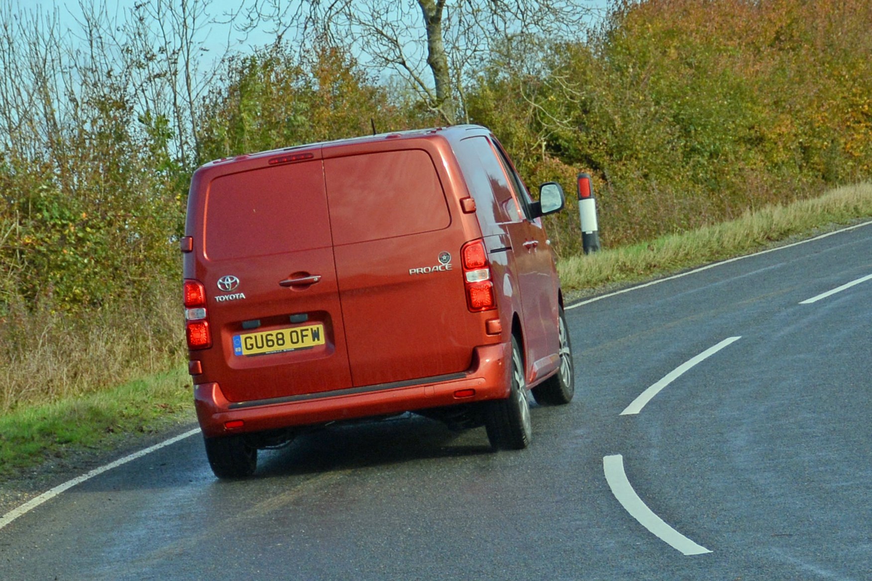 Toyota Proace automatic review - rear view, driving round corner, orange, 2019