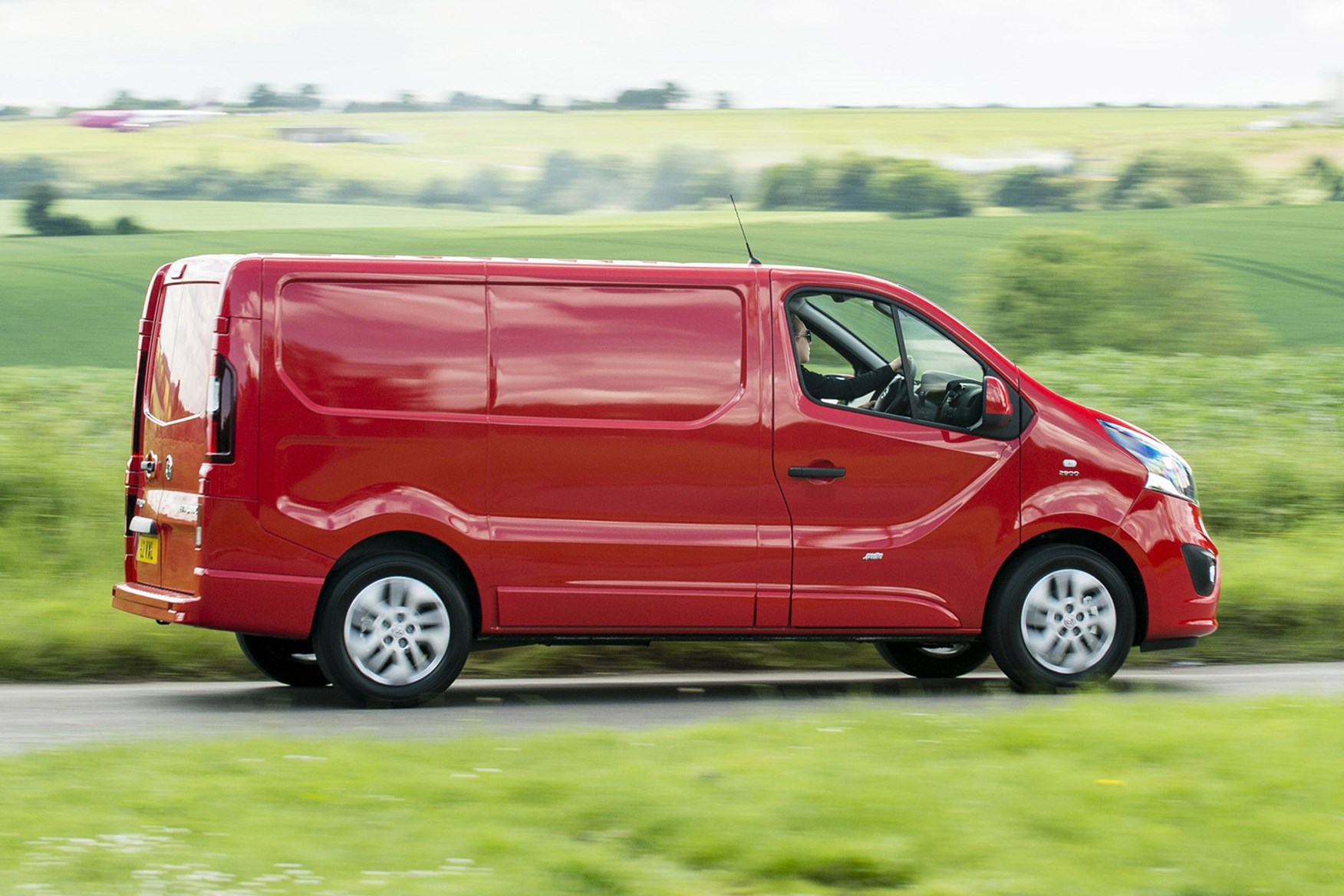 Vauxhall Vivaro review - side view, red, driving