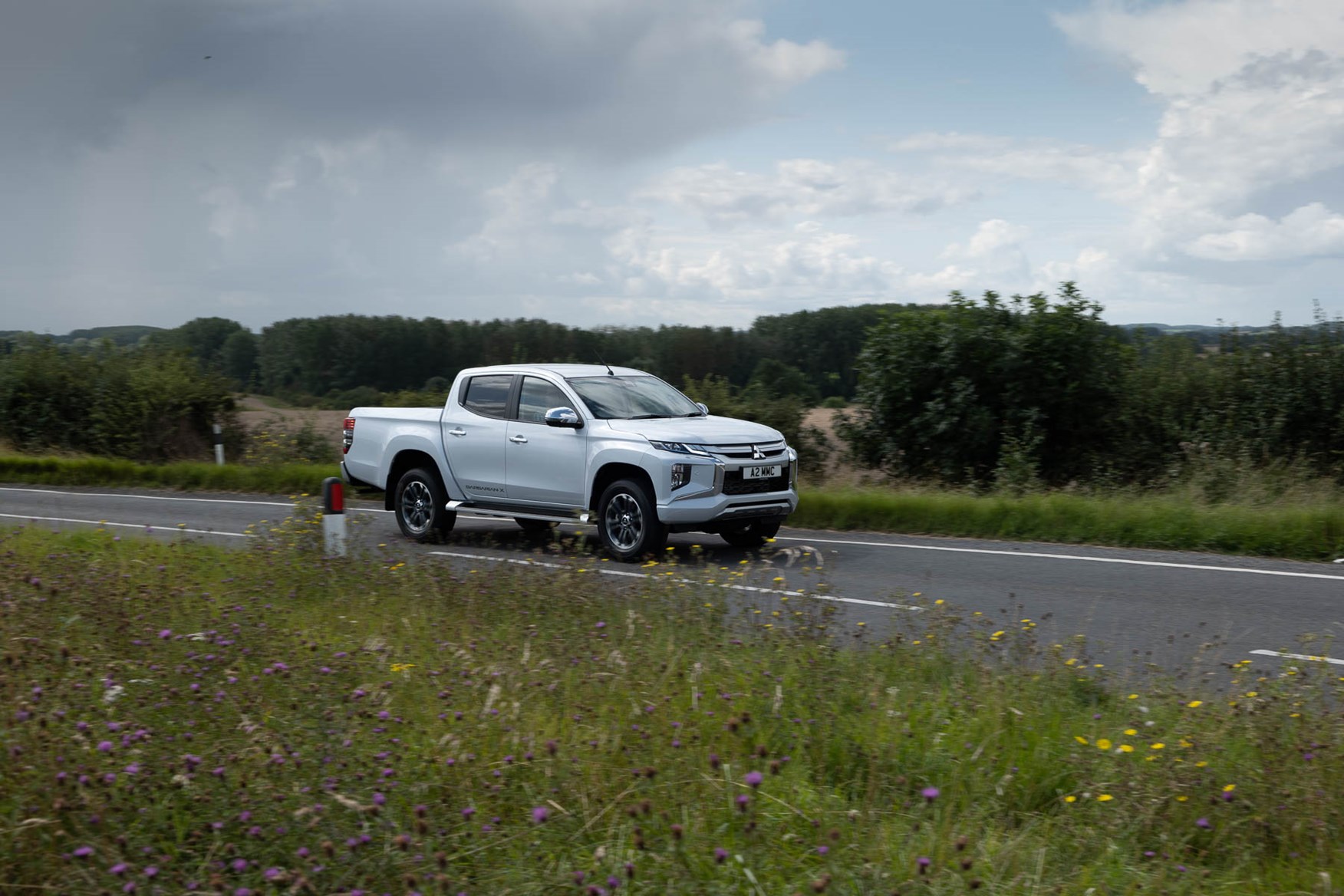 2019 Mitsubishi L200 pickup, driving. Barbarian X in Diamond White