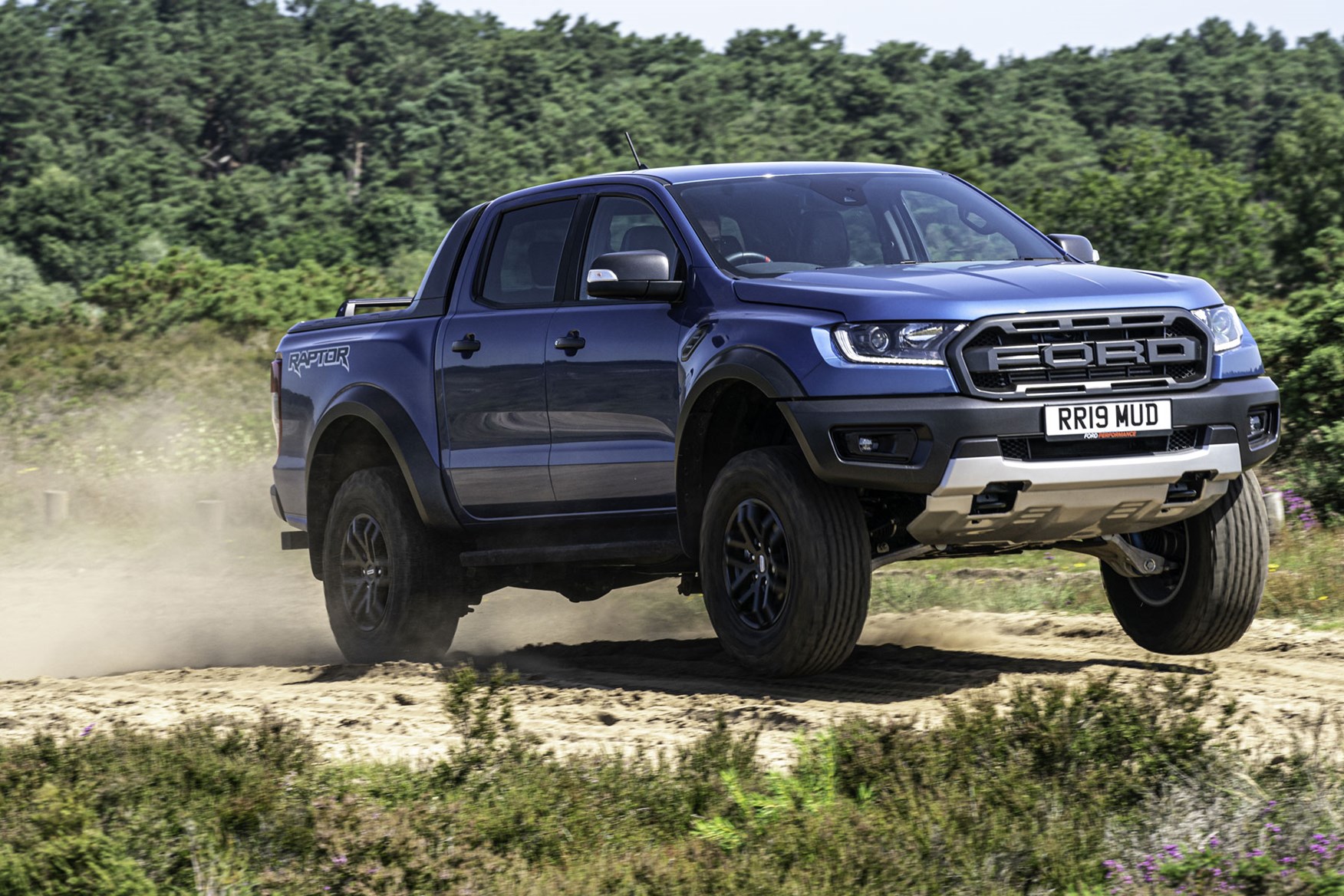 Ford Ranger Raptor review - front view, blue, jumping off road, 2019