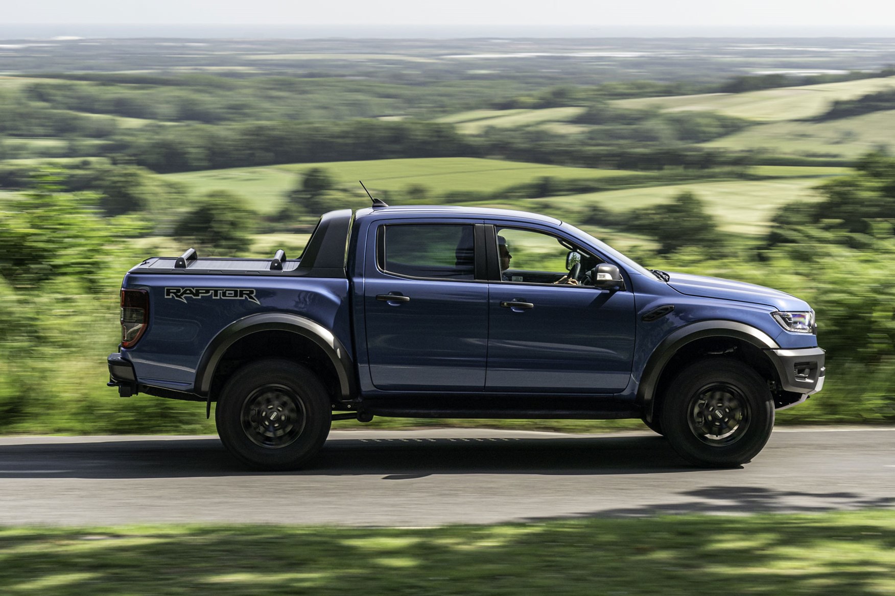 Ford Ranger Raptor review - side view, blue, driving on road, 2019