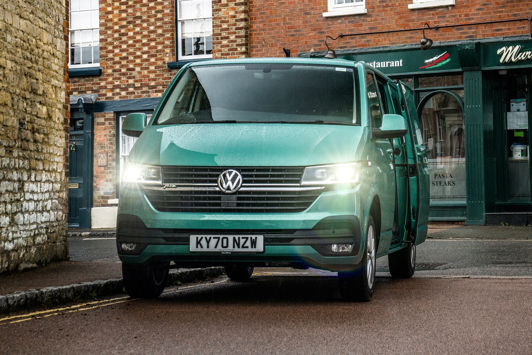 Volkswagen e-Transporter electric van review, 2020, front view, lights on, side door open, green