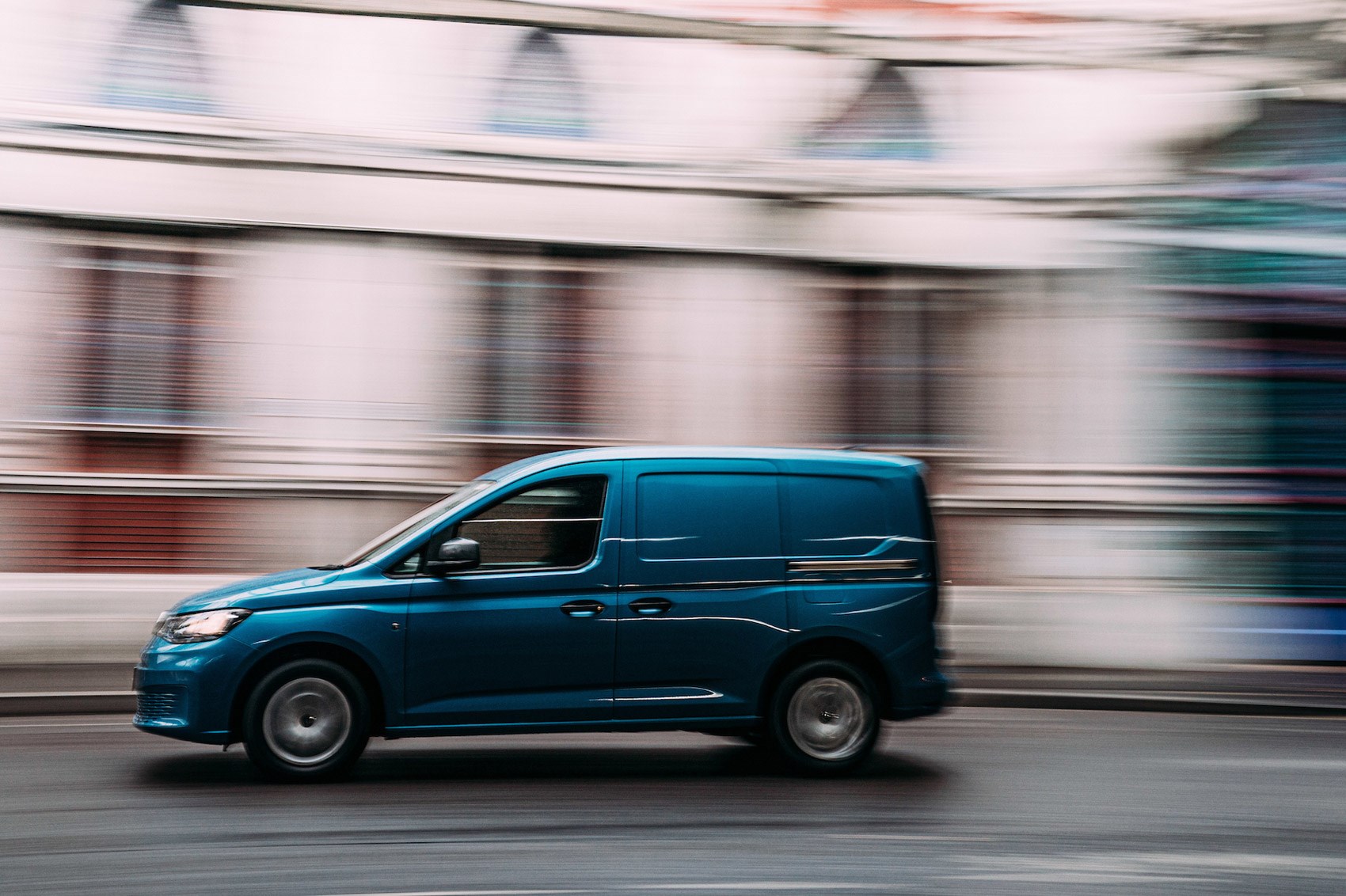 VW Caddy Cargo review, 2021, front side view, driving, blue