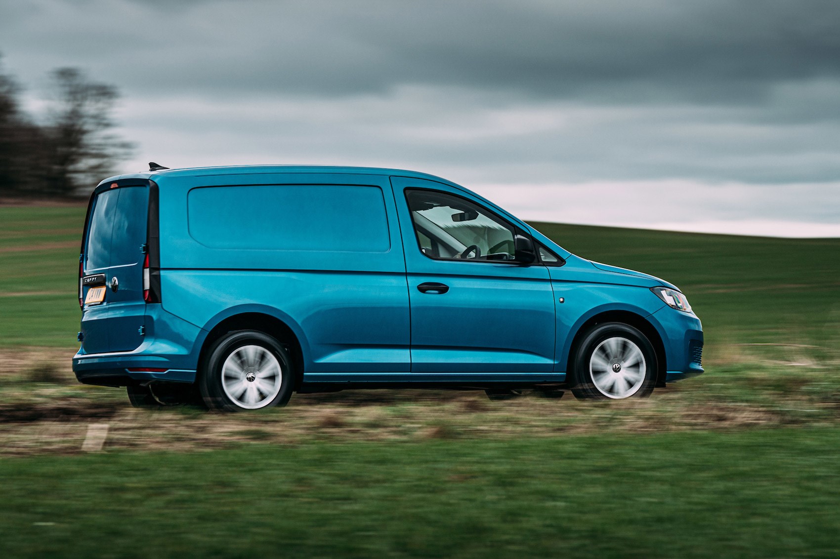 VW Caddy Cargo review, 2021, rear side view, driving, blue