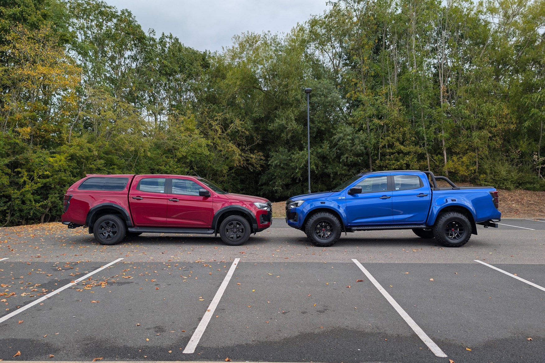 Isuzu D-Max on the left and AT35 Arctic Trucks on the right, with higher ride height and bigger tyres