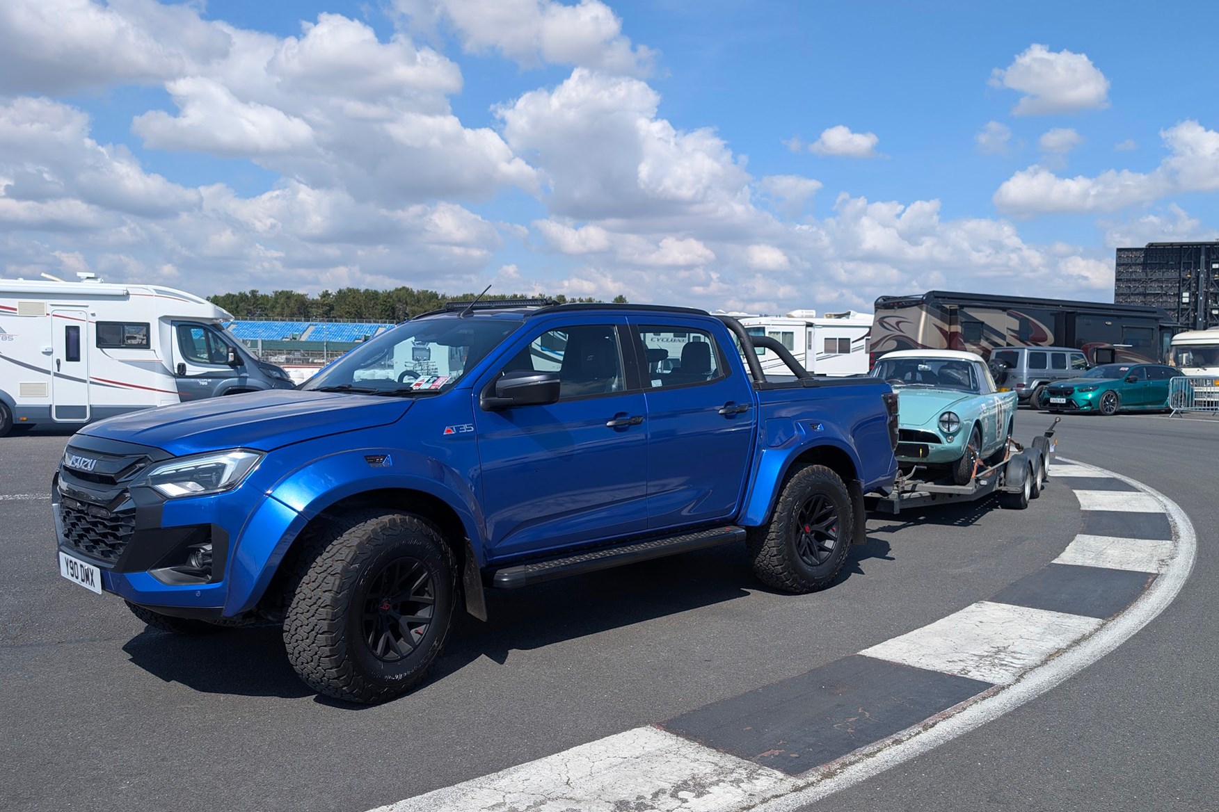 2025 Isuzu D-Max Arctic Trucks AT35 with a trailer, towing a Sunbeam Alpine racing car