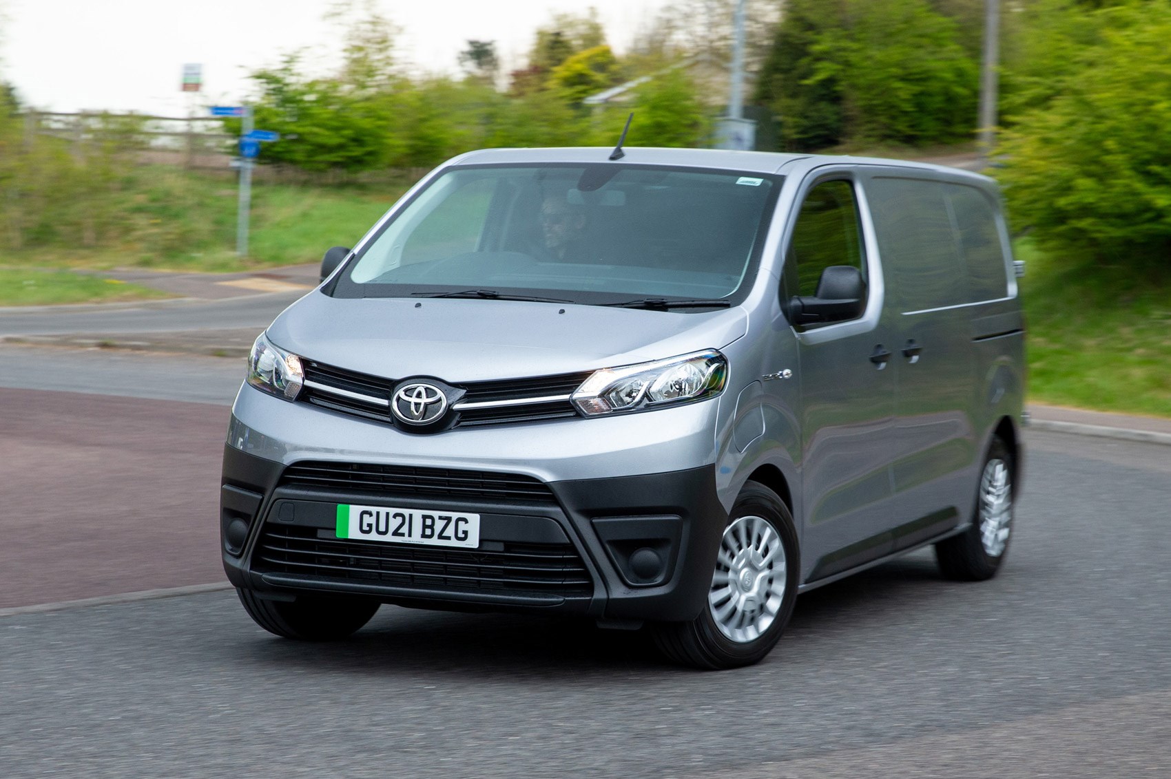 Toyota Proace Electric van review, front view, driving round corner, silver