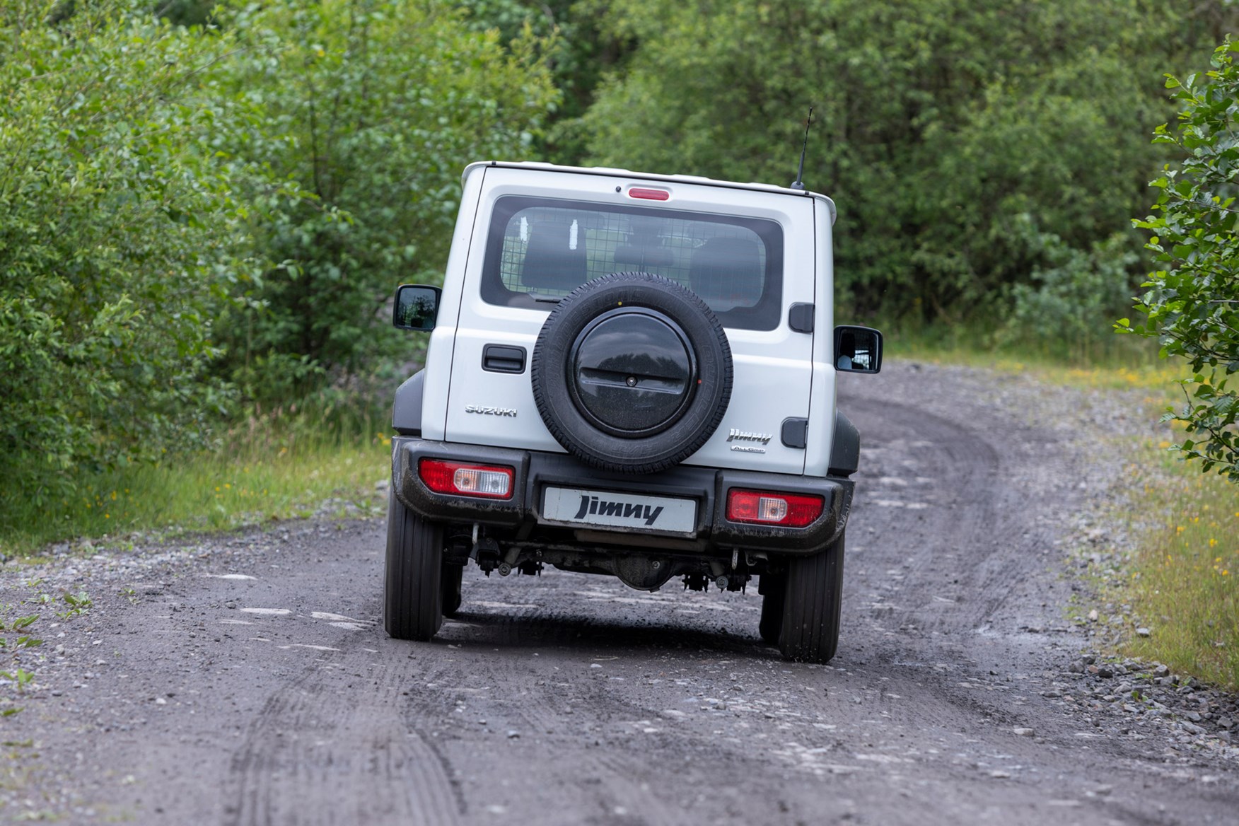 Suzuki Jimny commercial 4x4 review, 2021, rear view, white, driving on track