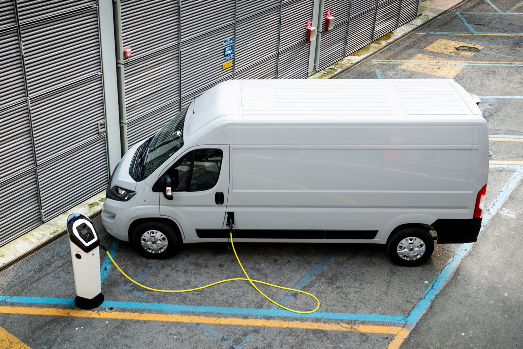 Fiat E-Ducato review - plugged in to charge, high view, white