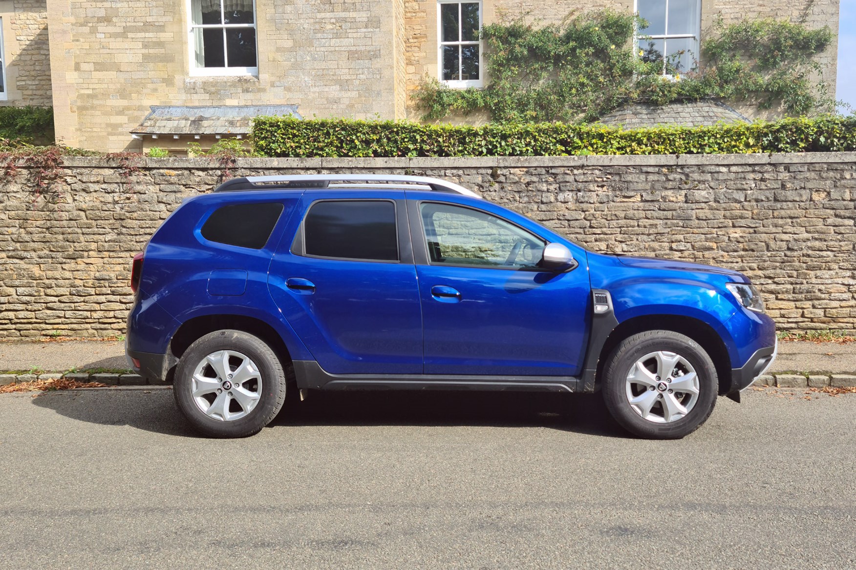 Dacia Duster Commercial review, side view, blue, village road