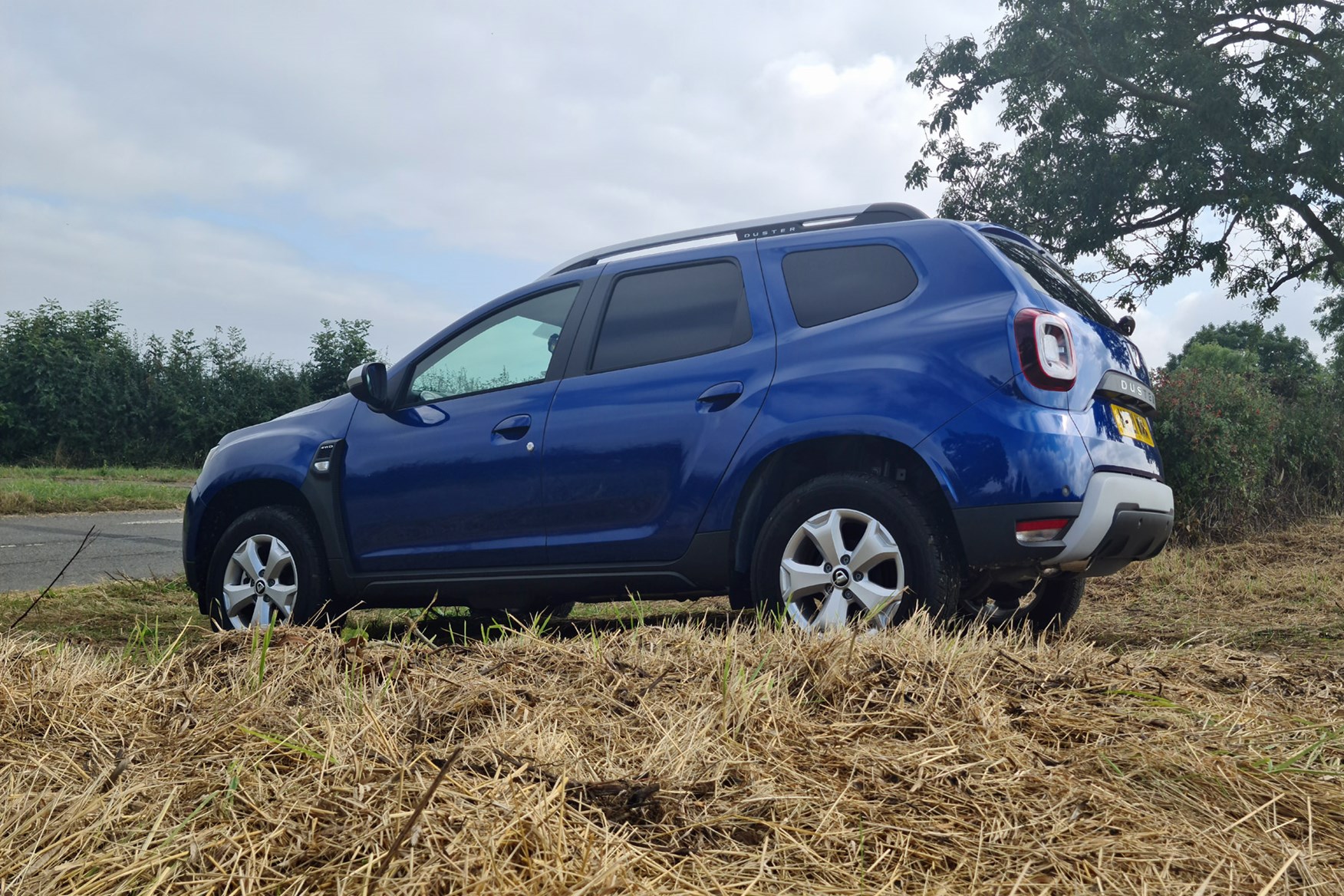 Dacia Duster Commercial review, side view, blue, off-road