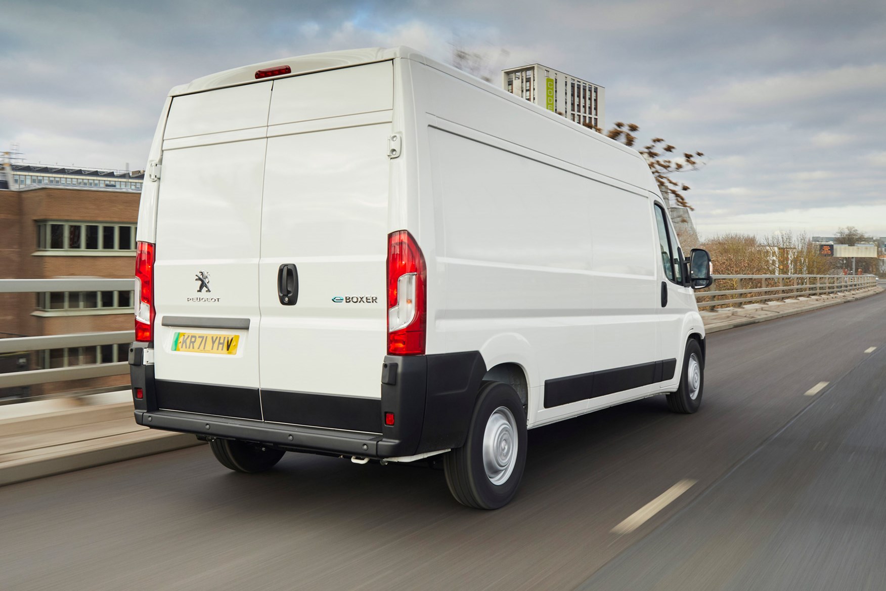 Peugeot e-Boxer electric van review - rear view, white, driving in countryside